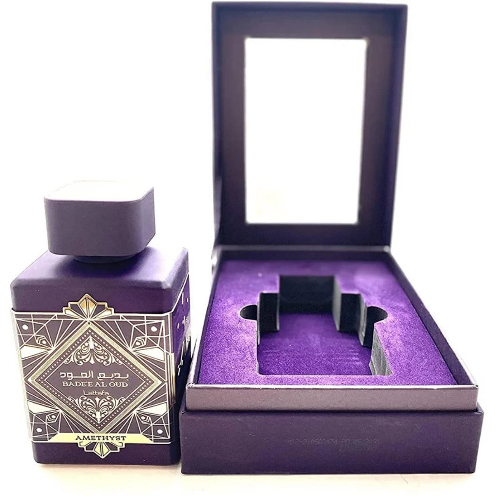 Purple jewelry box with a decorative bottle and amethyst stone inside on a white background