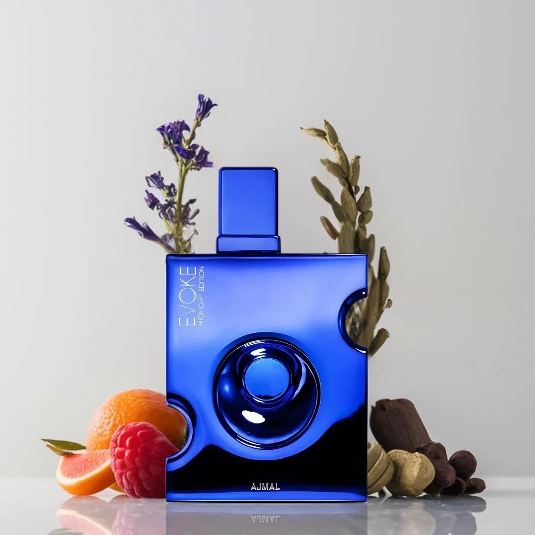 Blue perfume bottle with fruits and plants on a light gray background