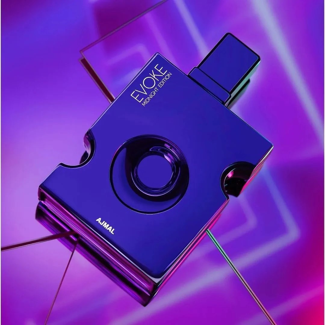 Blue perfume bottle with 'EVOKE' and 'AJMAL' branding on a vibrant purple background