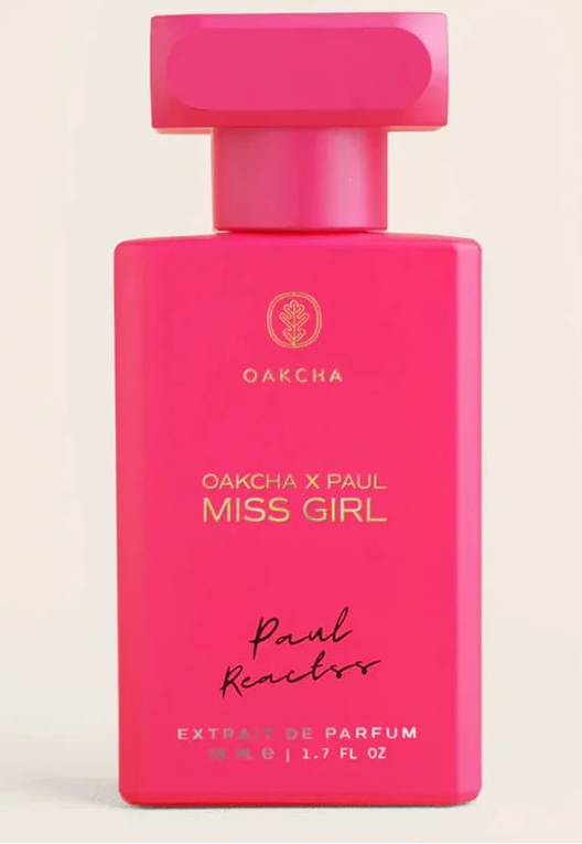 Pink perfume bottle labeled 'Miss Girl' by Oakcha on a beige background