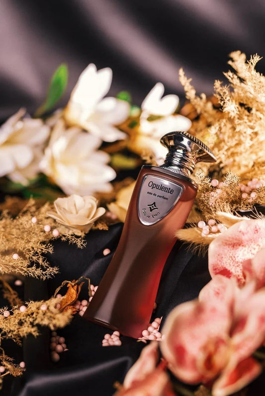 Oriflame perfume bottle with flowers in the background